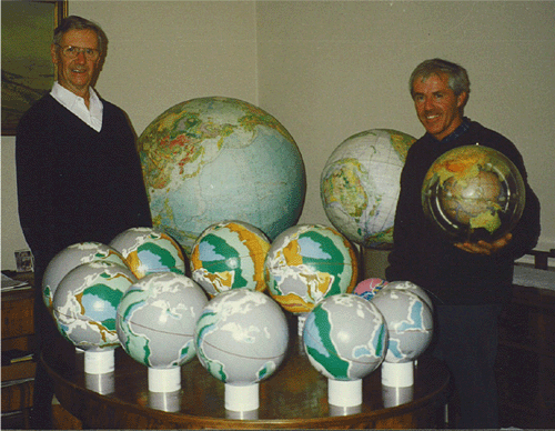 Klaus Vogel (left) and James Maxlow (right) displaying and comparing their Expanding Earth models at Klaus’ home in East Germany (1997). James’ first globes are displayed on the table, and james is holding Klaus’ famous globe-in-globe model.